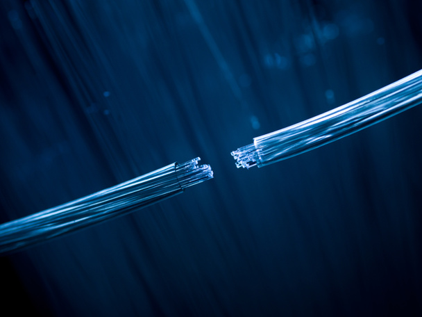 two fiber optic cables connecting on defocused background - Photo, Image