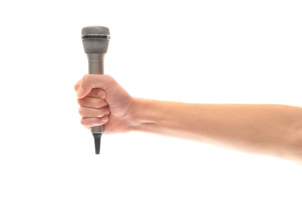 Hand and arm holding microphone isolated on white - Foto, afbeelding