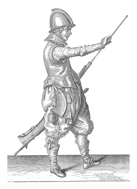 Ένας στρατιώτης, στα δεξιά κρατώντας ένα πηδάλιο (ένας συγκεκριμένος τύπος όπλου) με τον αριστερό μηρό του με το αριστερό του χέρι και τραβώντας το καλάμι του έξω από το βαρέλι με το δεξί του χέρι, vintage χαρακτική. - Φωτογραφία, εικόνα