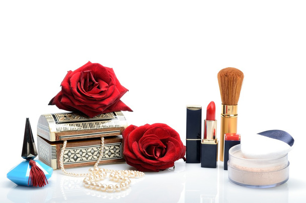 Cosmetics, perfumes, pearl beads, jewelry box and roses in a still life - Photo, Image