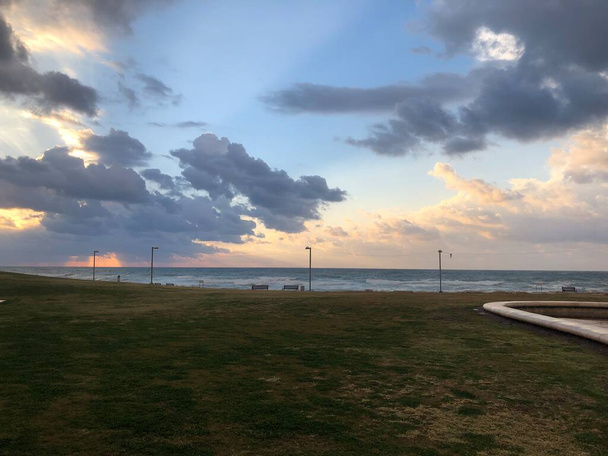 Захід сонця на пляжі Тель - Авіва Альма над морем, хмарне небо. - Фото, зображення