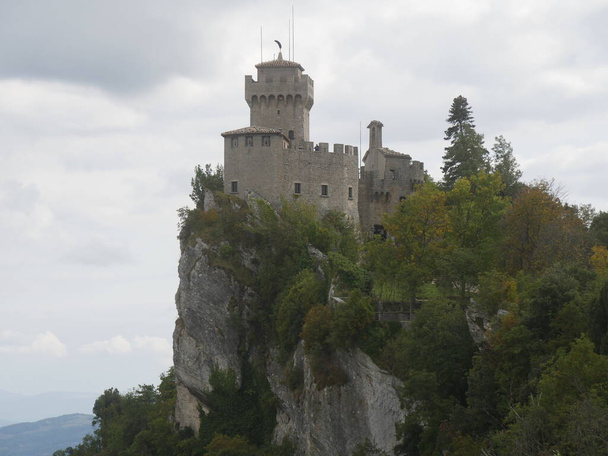 San Marino, the Witches Pass. Closeup on the Second Tower perched on the top of Titano Mount from the path with the stairway carved into the rock - Photo, Image