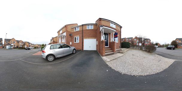 A 360 Degree Full Sphere Panoramic photo of a modern newly built house, showing the garden and garage doors on a typical British street - Photo, Image