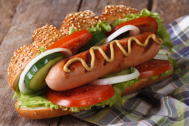 Hot dog with sausage, mustard and vegetables close up - Photo, Image