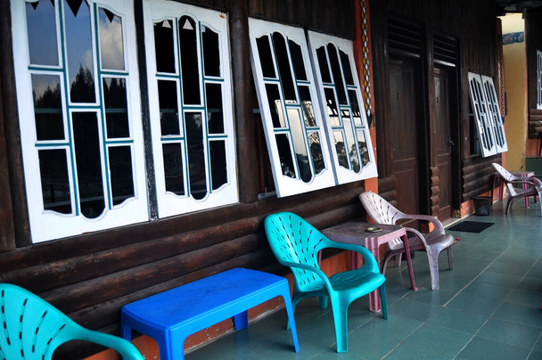 Terrace of classic vintage retro wooden building resort for Indonesian people living and foreign guest travelers travel visit rest relax in Kabupaten Karo at Sumatera Utara or North Sumatra, Indonesia - 写真・画像
