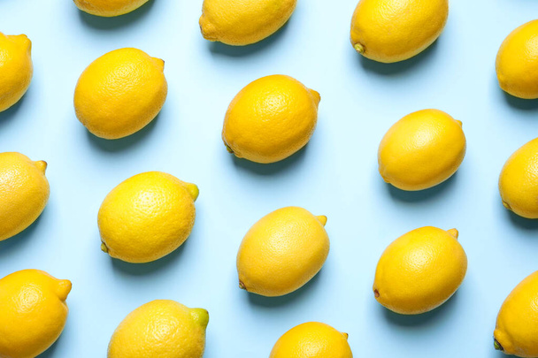 Many fresh ripe lemons on light blue background, flat lay - Photo, Image