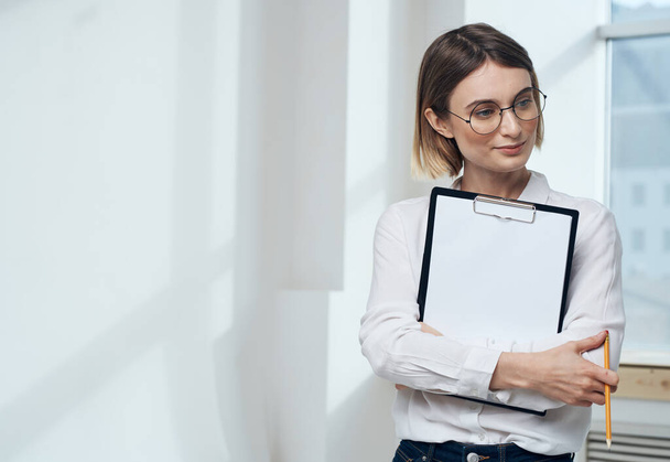 Business woman indoors with document folder white sheet mockup - Photo, Image