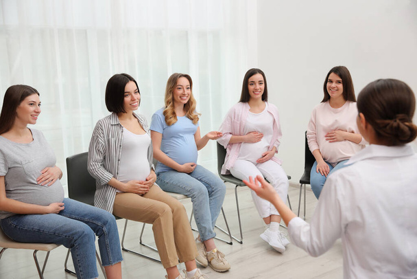Group of pregnant women with doctor at courses for expectant mothers indoors - Fotografie, Obrázek