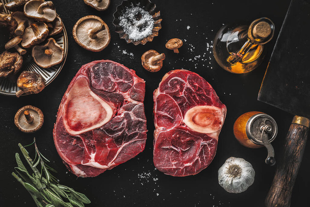 Raw meat with vegetables and spices on dark vintage background. View from above.  - 写真・画像