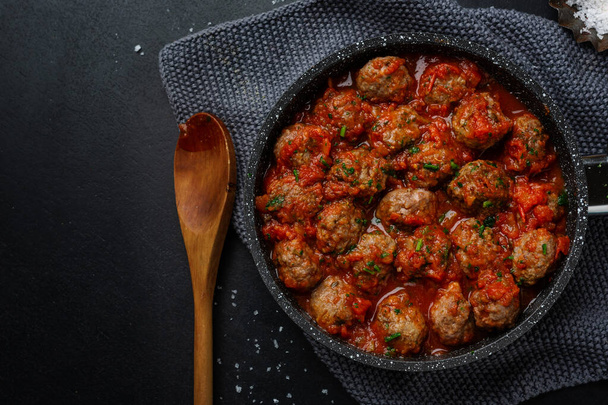 Meatballs with tomato sauce served on pan on dark background.  - Foto, Imagen