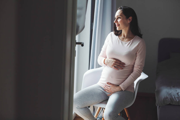 Pregnant woman sitting on chair. Lifestyle. Maternity concept.  - Φωτογραφία, εικόνα