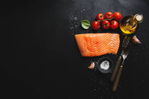 Raw salmon with spices on dark background. Top View  - Photo, Image