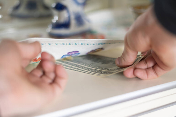 taking hidden stash of cash money from the wardrobe at home - Fotoğraf, Görsel