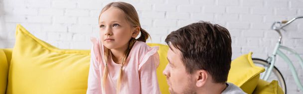 displeased girl looking away near father at home, banner - Photo, Image