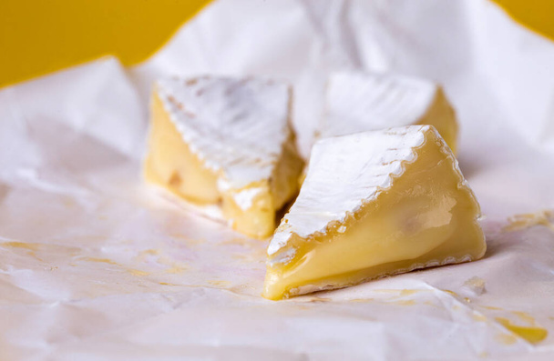 camembert cheese with honey on paper - Fotó, kép
