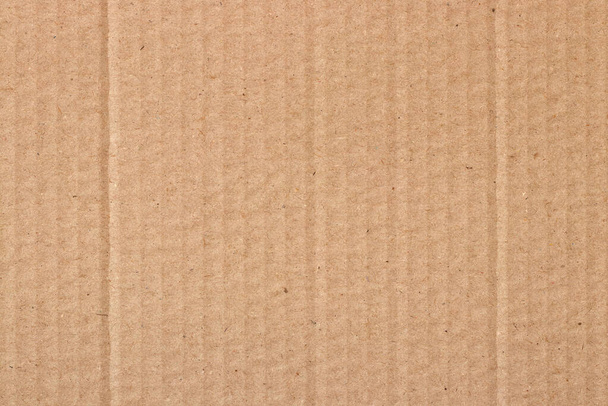 Коричневий картонний лист абстрактний фон, текстура переробки паперової коробки в старовинному вінтажному візерунку для дизайнерських художніх робіт
. - Фото, зображення