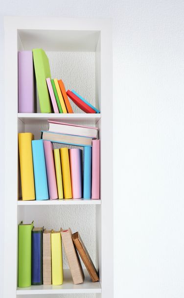 Books on white shelves in room - Photo, image