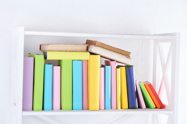 Books on white shelf in room - Foto, Imagem