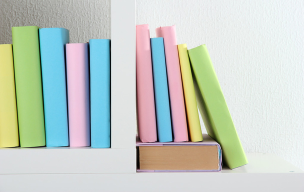 Books on white shelves in room - Foto, Imagem
