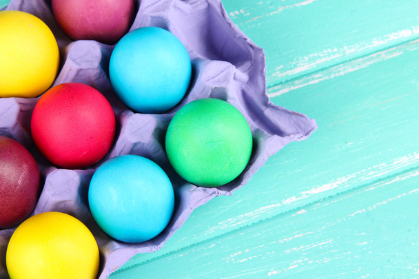 Colorful Easter eggs in tray on wooden background - Zdjęcie, obraz
