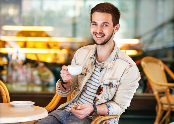 Young fashion man with beard drinking espresso coffee - Photo, image