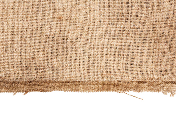 Brown burlap laying on white sheet. Abstract background. Texture of sackcloth. Background for banners, or wallpapers. Burlap Fabric Patch Piece, Rustic Hessian Sack Cloth - Photo, Image