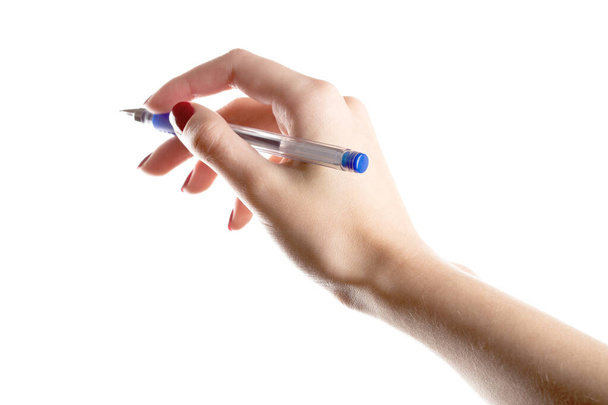 Female hands hold a pen isolated on white background - Valokuva, kuva
