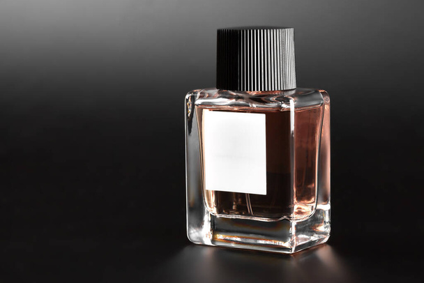 Bottle of perfume. Full jar of perfume on a dark background. - Foto, Imagen