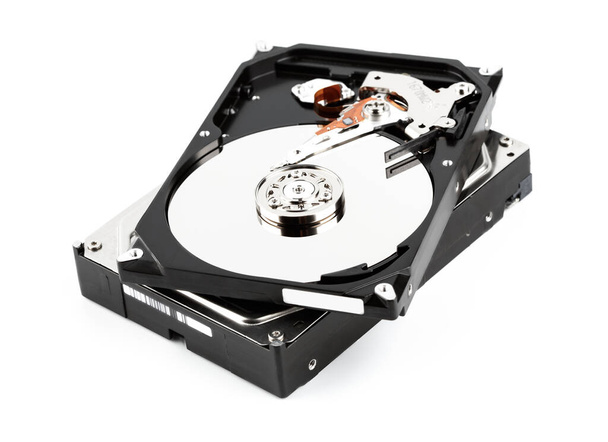 Hard drive isolated on white background. HDD. Major components of a 3.5-inch SATA hard disk drive: platter, spindle, actuator, actuator arm. Disk head above the plates - Photo, Image