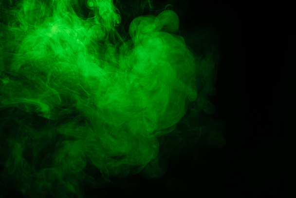 Green and pink steam on a black background. Copy space. - Photo, Image