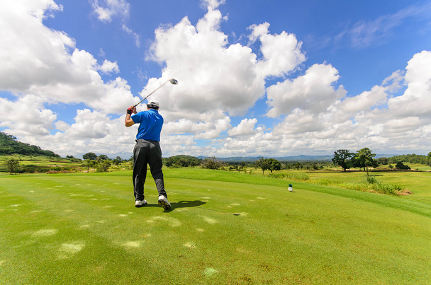 Golfer swinging his gear and hit the golf ball from tee to the f - Zdjęcie, obraz