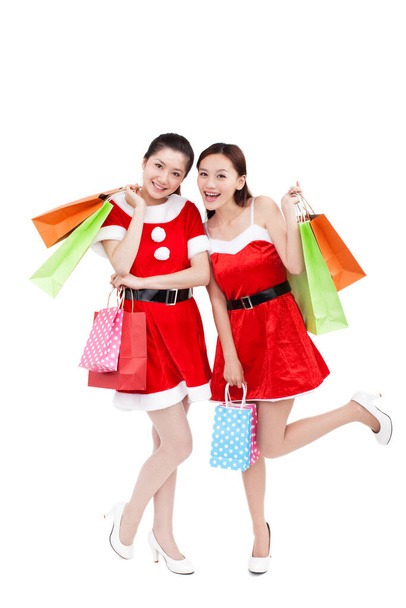 happy young women with shopping bags isolated on white - 写真・画像
