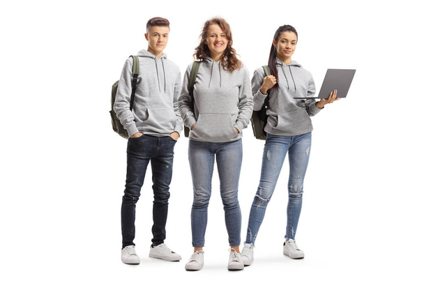 College students with backpacks and a laptop isolated on white background - Fotografie, Obrázek