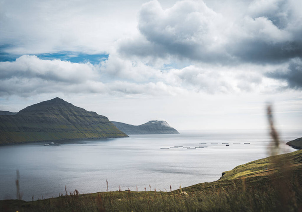 Outstanding panorama of Faroese Island cliffs and ocean mirror. Eysturoy, Faroe Islands, Denmark. - Fotografie, Obrázek