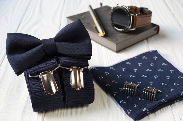 Состав деловых принадлежностей для мужчин в винтажном стиле - галстук-бабочка, подтяжки, носовой платок и запонки. - Фото, изображение