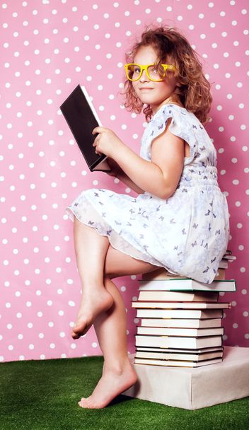 Cute young girl reading. - 写真・画像