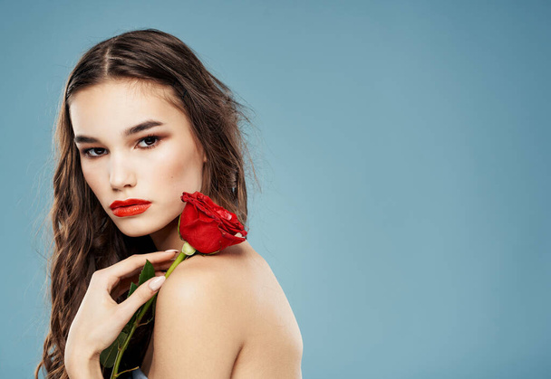Romantic people with a red rose in their hands on a blue background cropped view - Photo, Image