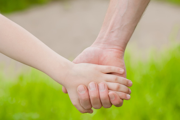 Hands of father and child in nature - Φωτογραφία, εικόνα