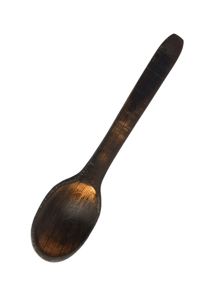 drewniana łyżka izolowana na białym tle. ciemnobrązowa łyżka rustykalna - Zdjęcie, obraz
