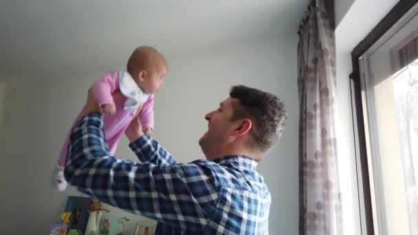 Happy father playing with little baby at home. Family, fatherhood concept - Footage, Video