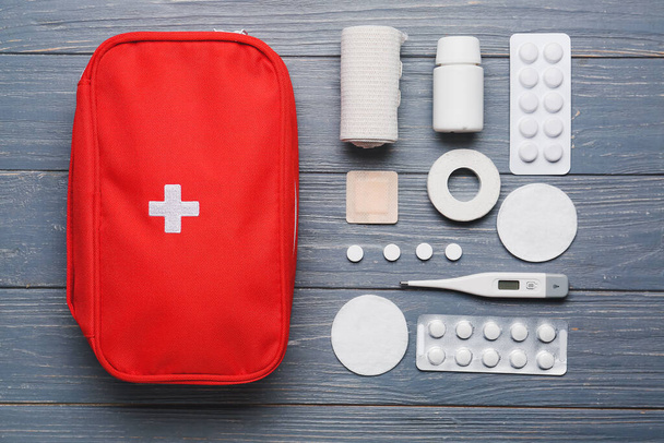 First aid kit on dark wooden background - Fotografie, Obrázek