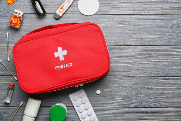 First aid kit on dark wooden background - Photo, Image
