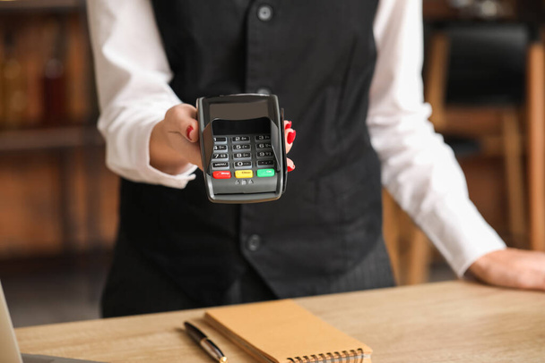 Waiter with payment terminal in cafe, closeup - Photo, Image