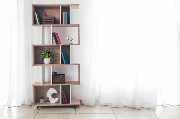 Modern interior with shelf unit and books in room - Fotografie, Obrázek