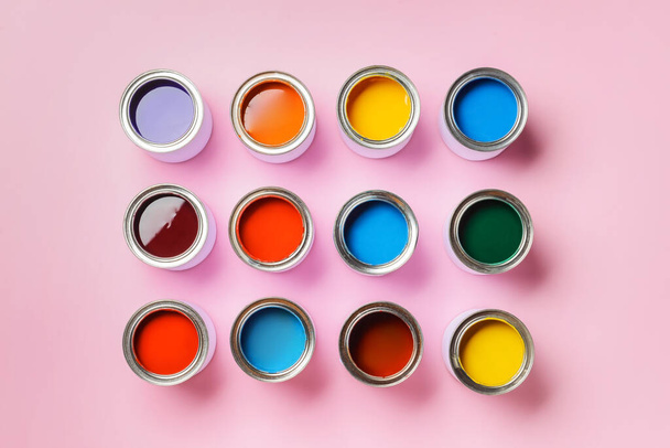 Cans of paints on color background - Photo, Image