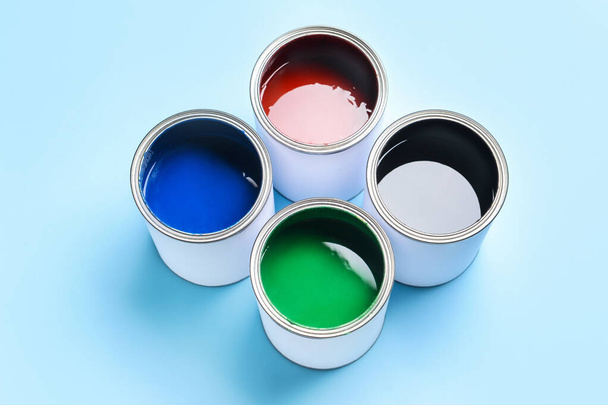 Cans of paints on color background - Photo, Image
