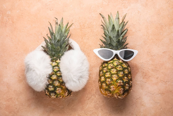 Pineapples with female accessories on color background - Photo, Image