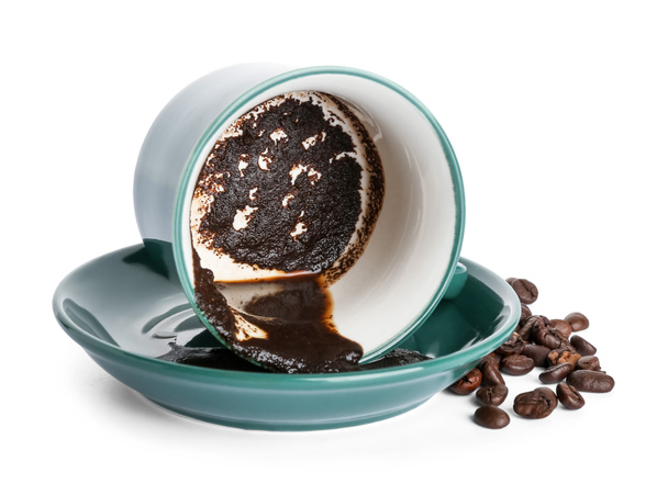 Cup with spent coffee grounds for fortune telling on white background - Photo, Image