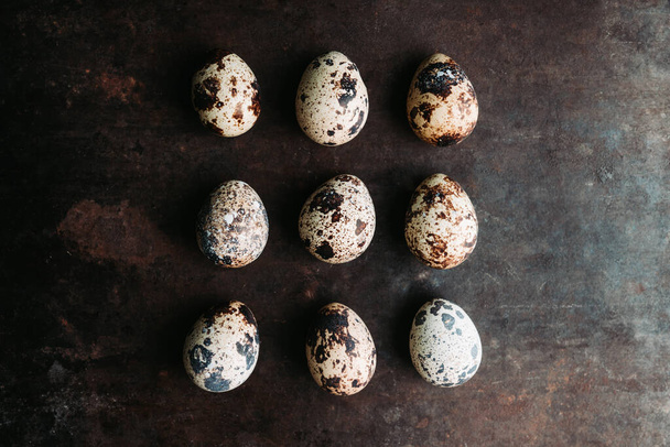 Quail eggs on the rustic background. Selective focus. - Foto, Bild