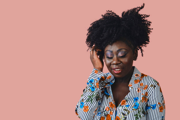 young beautiful african woman with afro hair, isolated on pink background - Photo, Image